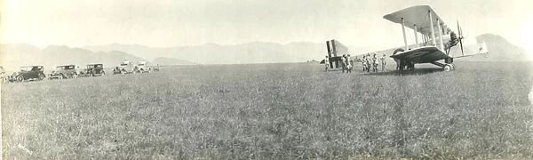 Biplane and cars in a field, India