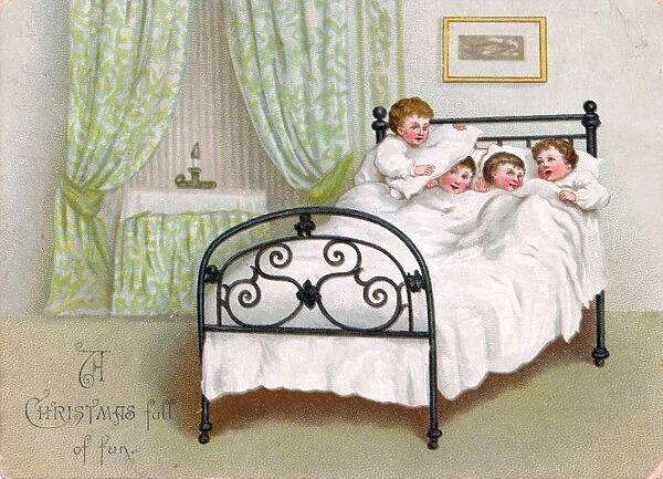 Four boys in bed on a Christmas card