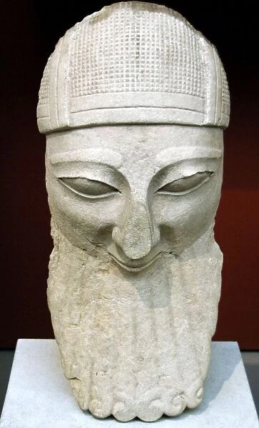 Head from a colossal statue of a bearded worshipper with hel