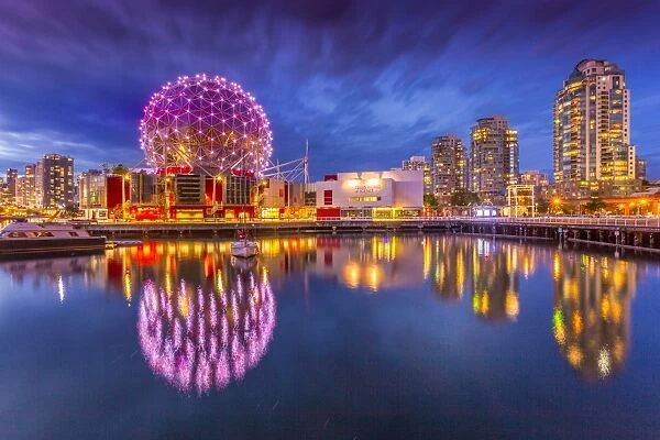 View of False Creek and Vancouver skyline, including World of Science Dome at dusk