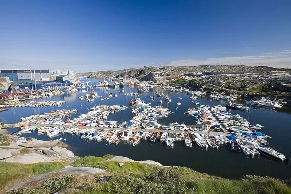 The harbour at Illulisat on Greenland. Ilulissat is a UNESCO World Heritage Site because of the Jacobshavn Glacier or Sermeq Kujalleq which is the largest glacier outside Antarctica. The glacier drains 7% of the Greenland ice sheet and produces