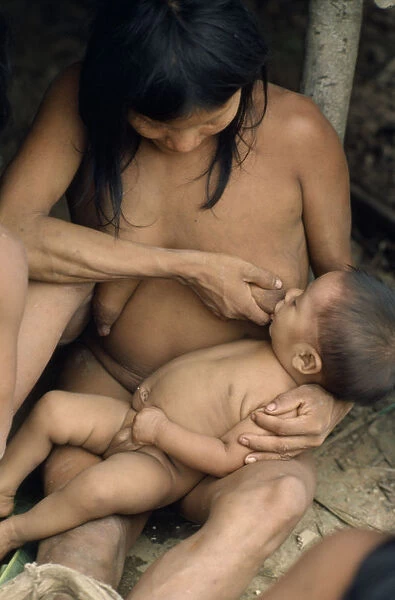 20076061. ECUADOR Amazonas Waorani tribeswoman breastfeeding baby