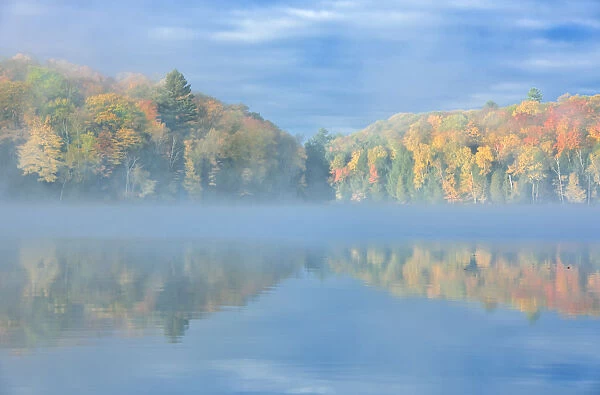Canada, Ontario, Horseshoe Lake. Cottage in morning fog on lake