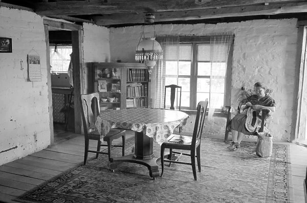 ADOBE HOUSE, 1940. A woman in an adobe house in Pie Town, New Mexico. Photograph by Russell Lee