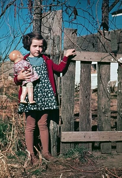 GIRL WITH DOLL, c1941. Portrait of a girl holding a doll. Photograph, c1941