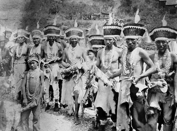 HUPA DANCE, 1893. A group of Hupa men and boys in costume at a Redheaded Woodpecker