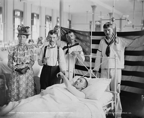Taking a patients pulse, Brooklyn Navy Yard Hospital, c. 1890-1901 (b  /  w photo)