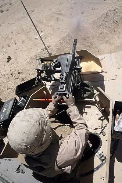 A 40 mm grenade flies from the muzzle of a MK-19 automatic grenade launcher