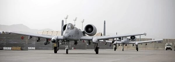 Two A-10 Thunderbolts taxi out to the runway