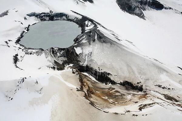 Aerial view of snow-covered Ruapehu volcano summit crater with acidic lake, New Zealand
