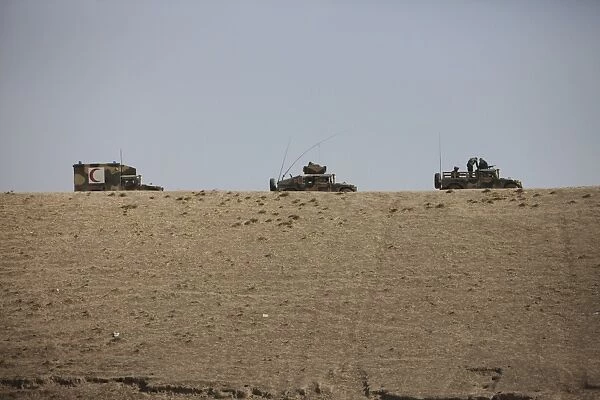 Afghan Army convoy drives along the wadi ridge in Afghanistan