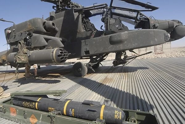 An AGM-114 Hellfire missile is ready to be loaded onto an AH-64 Apache