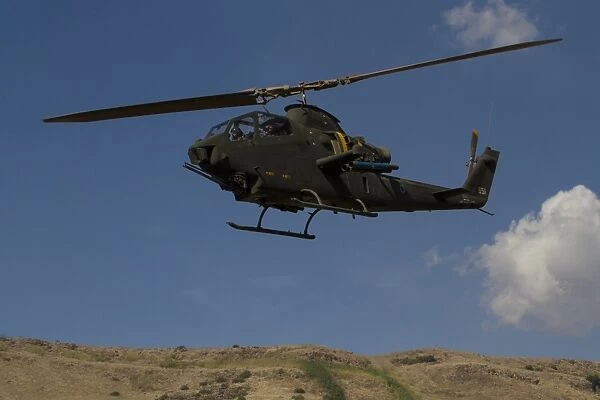 An AH-1F Tzefa of the Israeli Air Force flying over the Golan Heights, Israel
