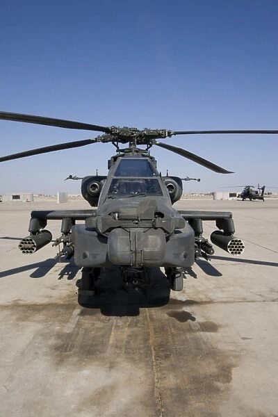 An AH-64D Apache Longbow Block III attack helicopter sits on the flight line