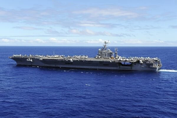 The aircraft carrier USS Abraham Lincoln transits across the Pacific Ocean