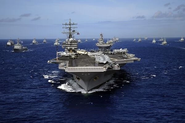 Aircraft carrier USS Ronald Reagan leads a mass formation of ships through the Pacific