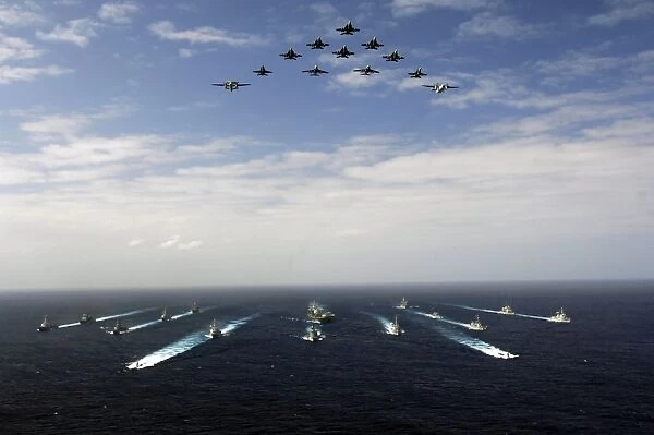 Aircraft fly over a group of U. S. and Japanese Maritime Self-Defense Force ships