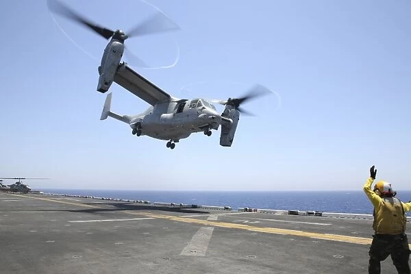 Airman directs the take-off an MV-22 Osprey