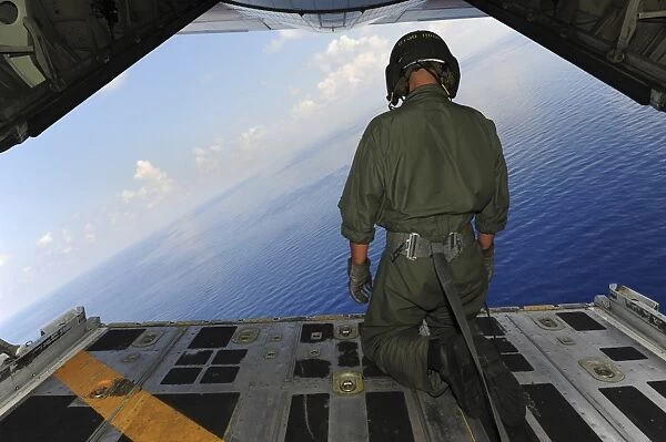 Airman observes the waters of the Gulf of Mexico from a C-130 Hercules