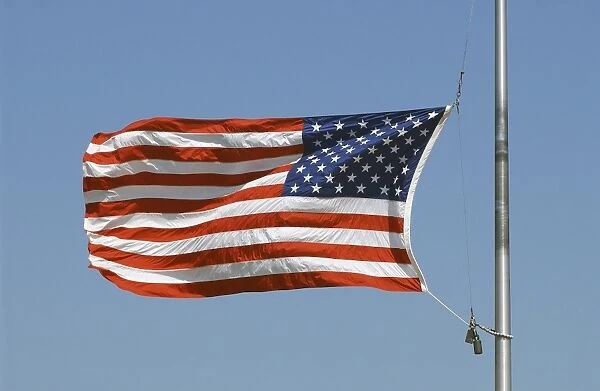 The American flag waves at half-mast