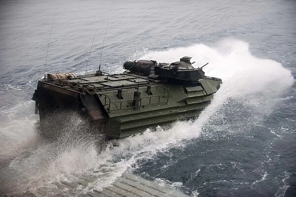 An amphibious assault vehicle departs the well deck of USS New Orleans