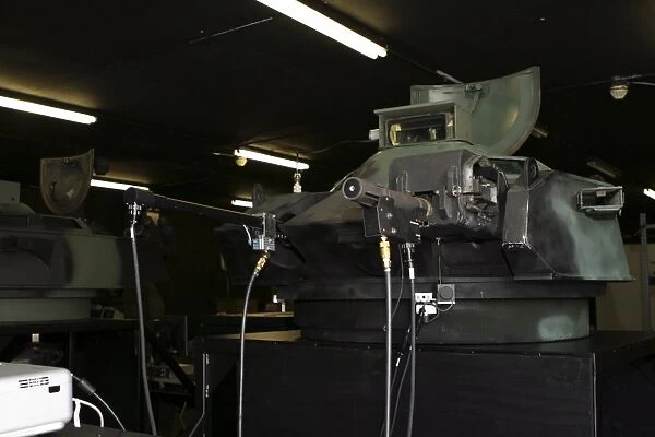 An amphibious assault vehicle turret trainer sits in an old armory building