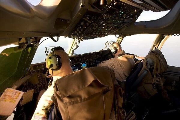 US Army Pilots in-flight in the cockpit of a C-17 Globemaster III during a mission