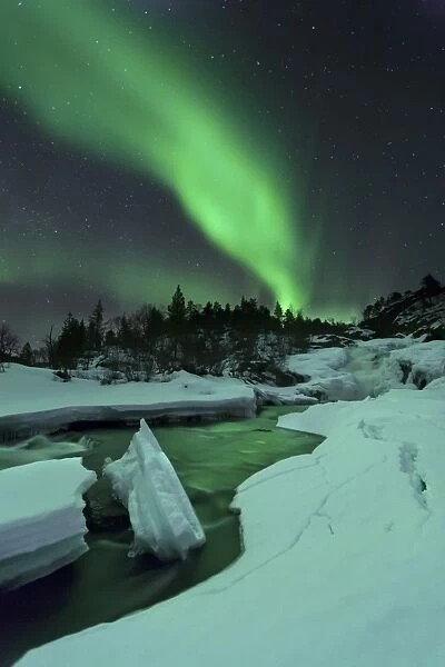 Aurora Borealis over a frozen Tennevik River, Troms, Norway