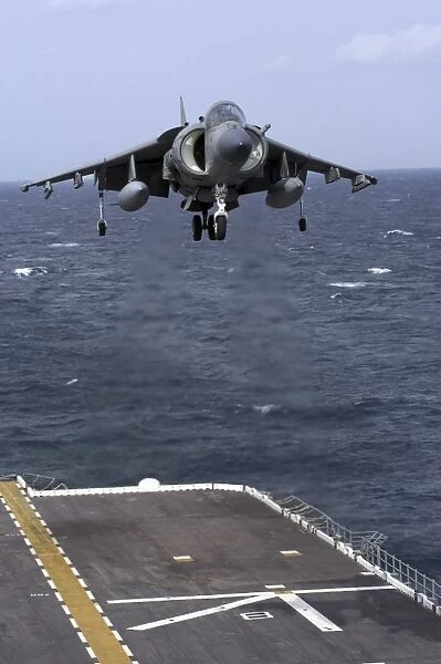 An AV-8B Harrier II prepares to land on the flight deck of USS Nassau