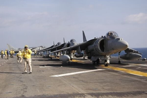 Four AV-8B Harrier jets line up for take-off aboard USS Essex