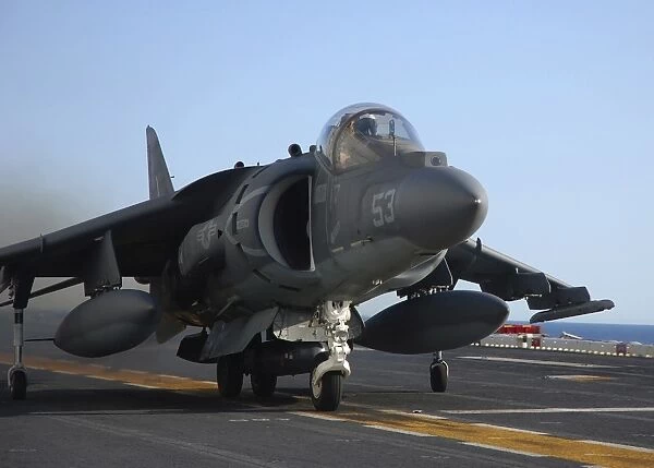 An AV-8B Harrier launches from the flight deck of USS Peleliu