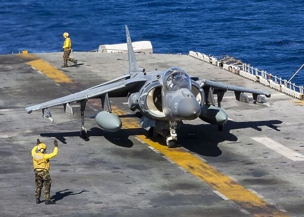An AV-8B Harrier prepares to take off from the flight deck of the USS Kearsarge
