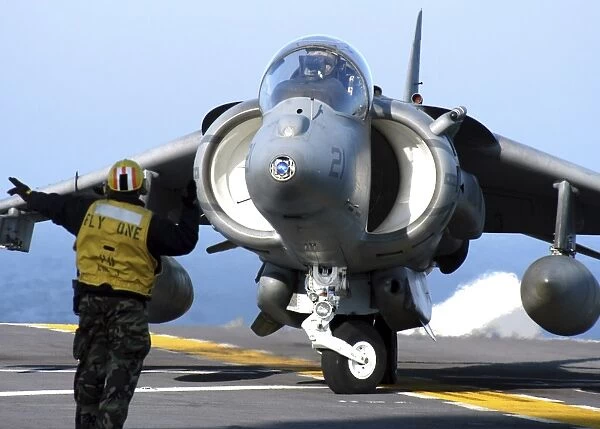 Aviation Boatswains Mate directs an AV-8B Harrier