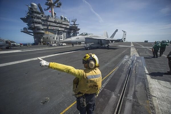 Aviation Boatswains Mate directs an F  /  A-18E Super Hornet