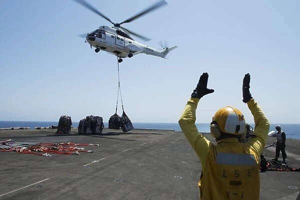 Aviation Boatswains Mate directs an SA-330J Puma helicopter