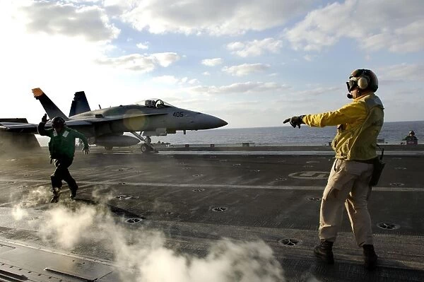 Aviation Boatswains Mate ensures an F  /  A-18C Hornet is cleared for launch