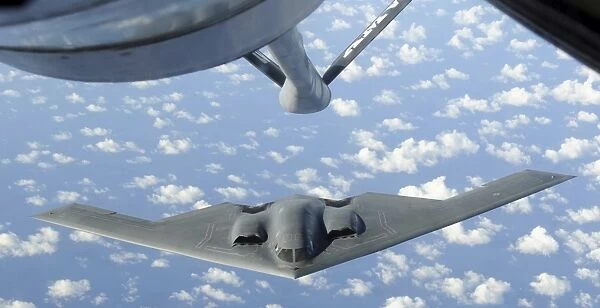 A B-2 Spirit approaches the refueling boom of a KC-135 Stratotanker