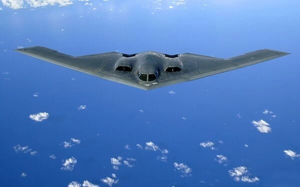 A B-2 Spirit soars through the sky after a refueling mission