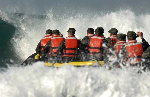Basic Underwater Demolition  /  SEAL students encounter a large wave during a surf passage