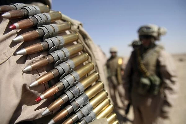 Belts of. 50-caliber ammunition hang from the shoulders of Marines