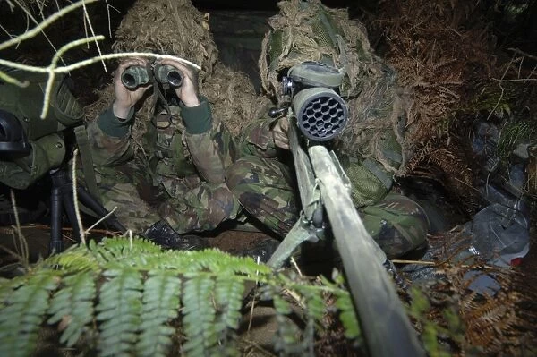 A British Army sniper team dressed in ghillie suits