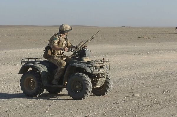 A British Army soldier provides security on a ATV