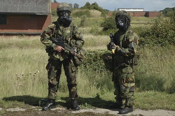 Two British soldiers in full NBC protection gear