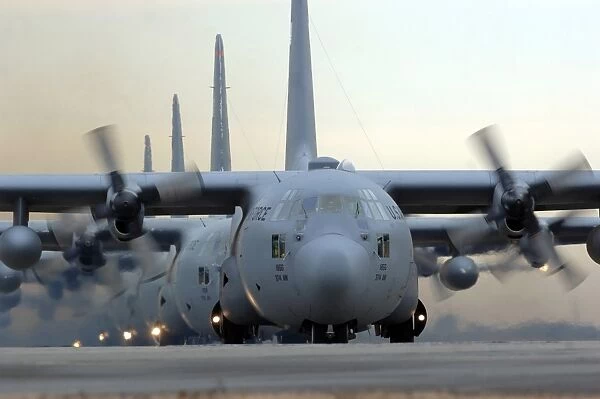 C-130 Hercules aircraft taxi out for a mission during a six-ship sortie