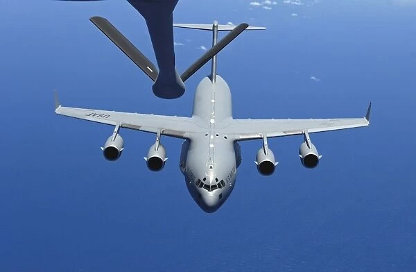 A C-17 Globemaster III approaches the boom of a KC-135 Stratotanker