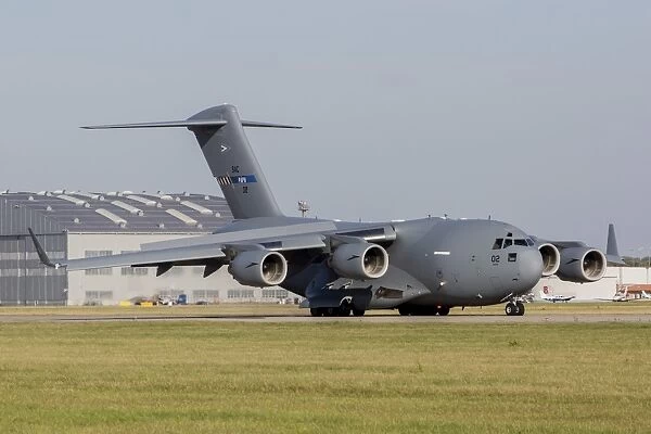 A C-17 Globemaster strategic transport aircraft taxiing on the runway