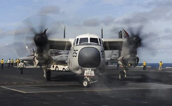 A C-2A Greyhound moves onto the flight deck of USS Nimitz