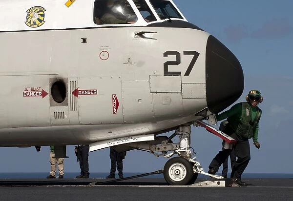 A C-2A Greyhound undergoes flight preparations