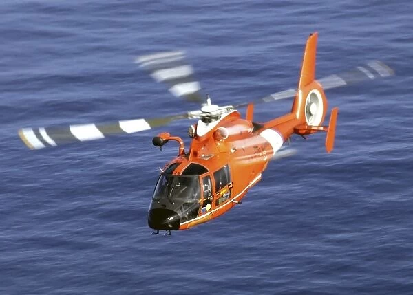 A Coast Guard HH-65A Dolphin rescue helicopter in flight