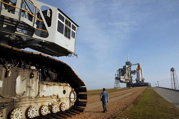 The crawler-transporter moves away after carrying Space Shuttle Discovery to the